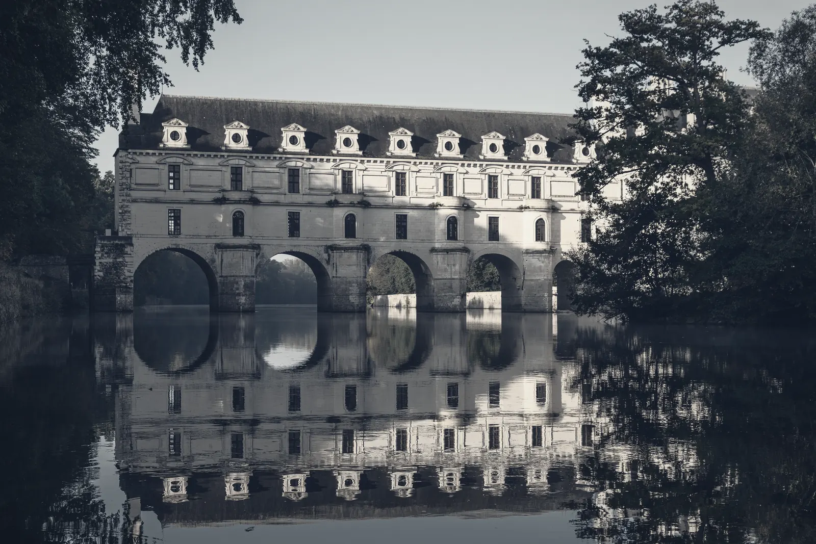 A renaissance chateau standing in the river it was built across