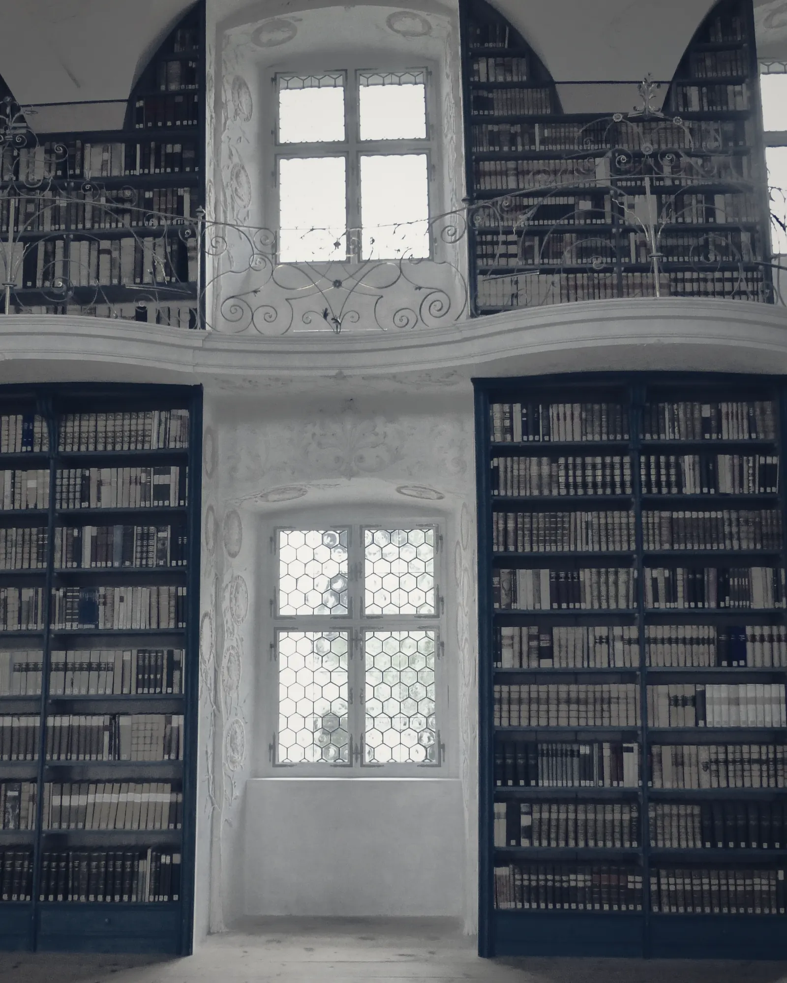 Gilded shelving and painted vaulting in an abbey library