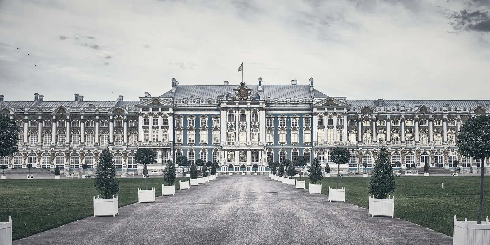 The long symmetrical facade of a European palace across its forecourt