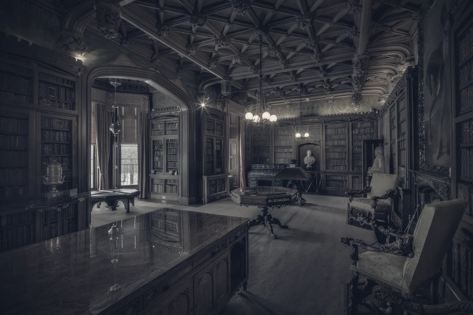 A panelled reading room with a long working table